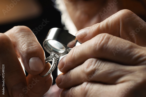 Professional jeweler working with ring, closeup view