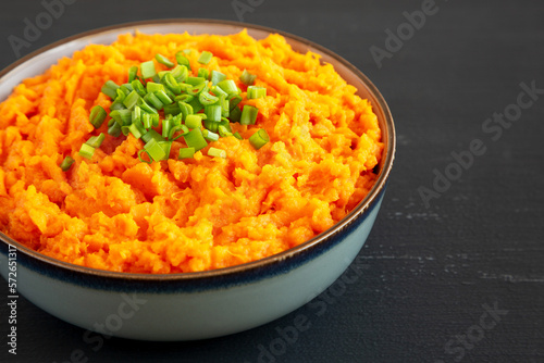 Homemade Creamy Mashed Sweet Potatoes with MIlk and Butter in a Bowl, side view. Copy space.