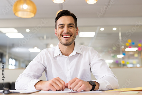 Image of caucasian man having video call on laptop in office