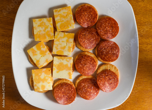 crackers top with colby jack cheese and pepperoni