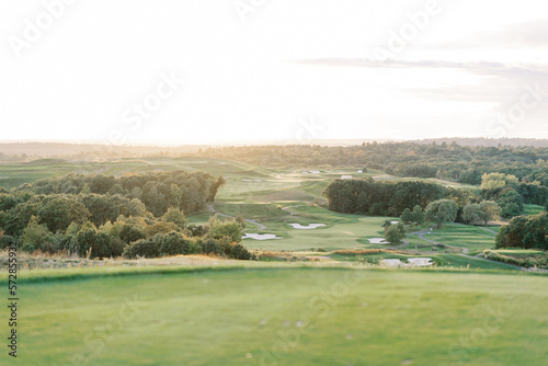 golden sunset light over a well manicured lush green golf course