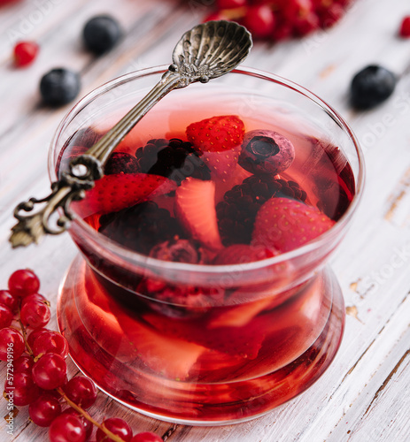 Jelly with fresh berries on wooden table close up