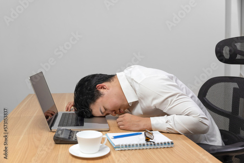 Man with narcolepsy is fall asleep on office desk..Narcolepsy is a sleep disorder that makes people very drowsy during the day. 