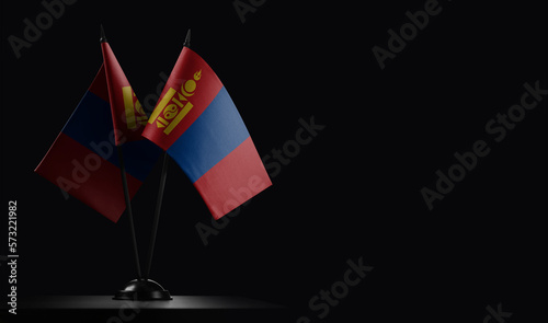 Small national flags of the Mongolia on a black background
