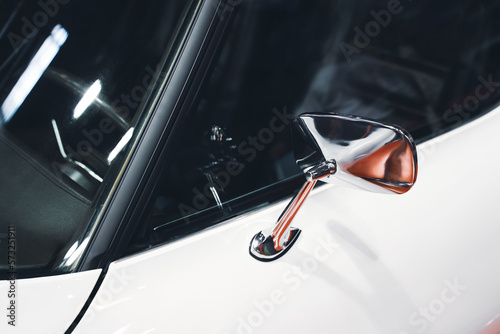 chrome rear mirror on white car with classic design