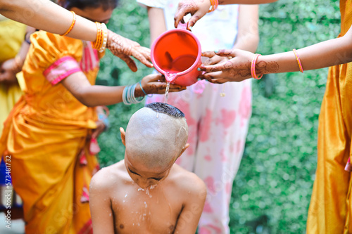 Boy Bathing for hindu worship ceremony. Holy spring water. Traditional Indian boy thread ceremony rituals. Maharashtra culture