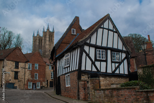 Old english house with view of lincoln cathedral church behind 