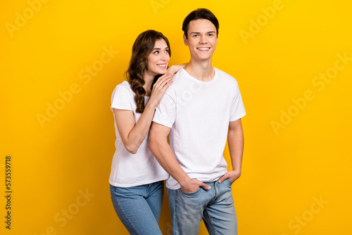Photo portrait of young cheerful satisfied husband with wife wear white t-shirt touch shoulder look candid isolated on yellow color background