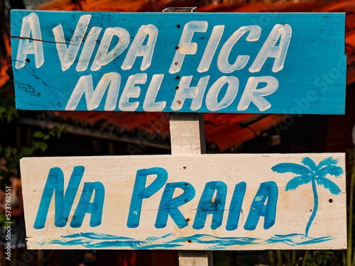 Two wooden signs with the inscription: Life is better at the beach. blurred background, wooden tablet, illustration