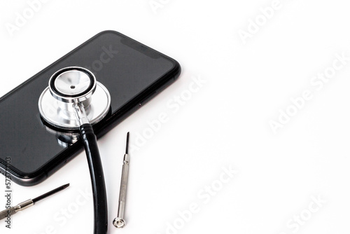 Electronics repair servise concept - mobile phone with stethoscope