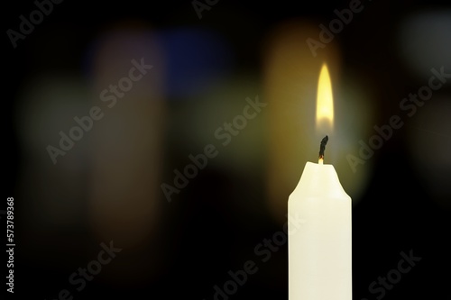 Abstract burning candle on dark background