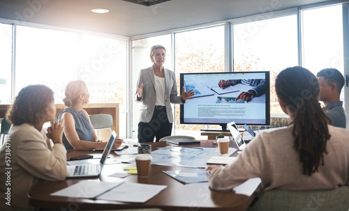 Business leader, woman and slideshow at team building seminar for company growth. Working, market research data and workshop of a female manager meeting with marketing group in office with tech