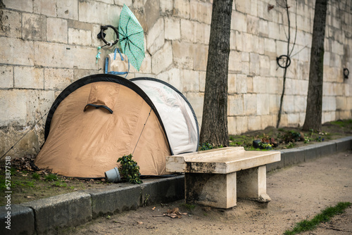 Homeless man in a tent near the wall on the river bank in Paris France. Life on the street. Homeless life. When you don't have your own home and job. The life of a poor man. Homeless man in a tent