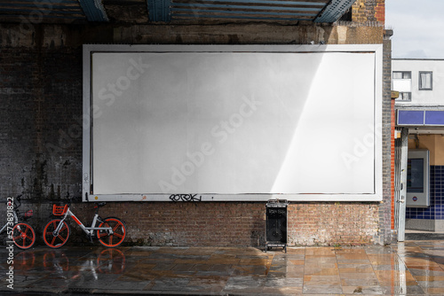 Blank billboard sign mockup in the urban environment, on the facade, empty space to display your advertising or branding campaign