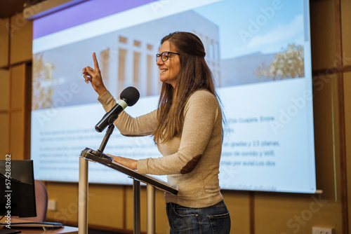 University professor giving a masterclass at the graduation of her university students. Concept: conference, speech, audience