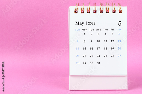 A May 2023 desk calendar on pink color background.