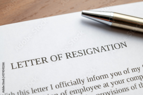 Employee resignation letter and pen beside. 