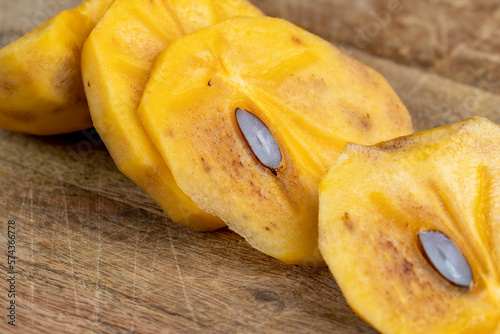 Half-ripe Orange persimmon, close up