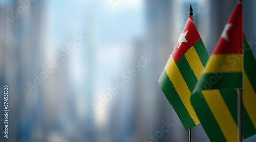 Small flags of the Togo on an abstract blurry background