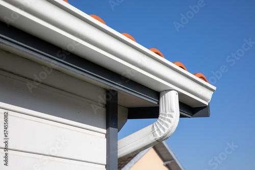 Roof showing gutters aluminum and soffit on the back of wooden house