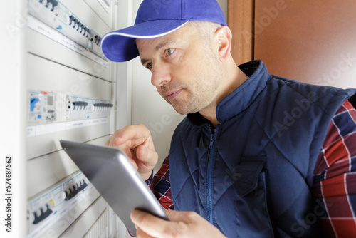 portrait of electrician worker inspecting electric meter