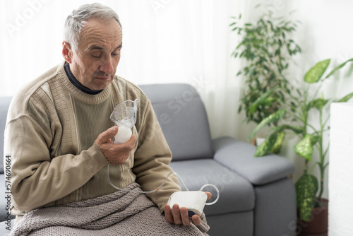 Elderly Senior Man nursing care wear oxygen inhaler device for helping breath respiratory. Oxygen Concentrator portable