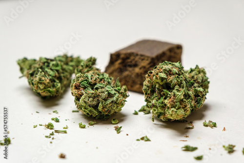 High quality marijuana, cannabis, weed buds and a piece of dry hashish on a white background