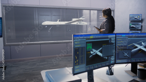 Engineers check aerodynamics of new development drone in laboratory for modern modifications using wind tunnel with steam. Computer system for changing parameters. Concept of manufacturing UCAVs.