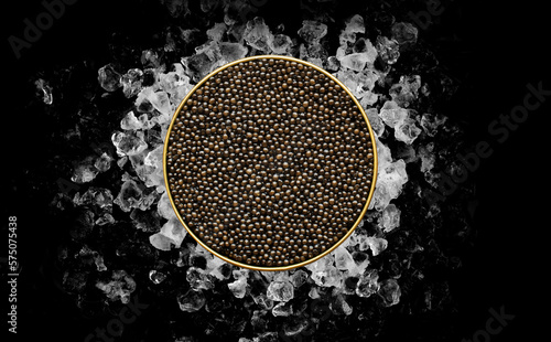 Tin of Caviar on ice on black background
