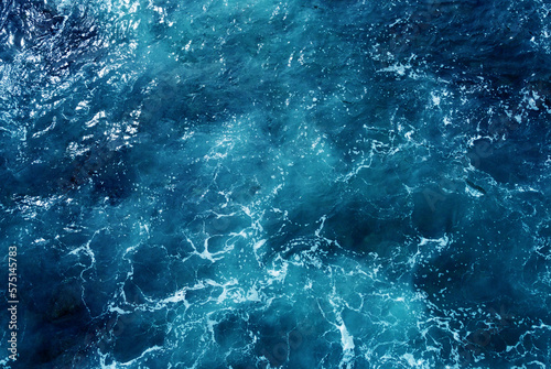 Aerial view of the ocean water surface and waves. Beautiful water background texture for tourism and advertising. Tropical coast