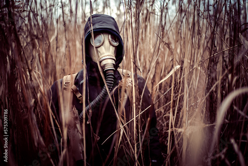 Person with gasmask in bushes