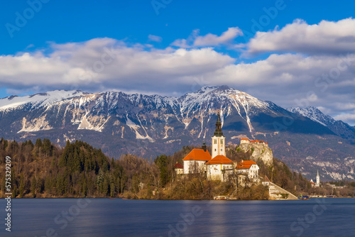 Bled lake with Bled catle, church and winter Julian Alps at background
