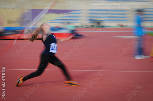 Unrecognized athlete doing javelin spear throw in a sport competition. Javelin thrower at stadium