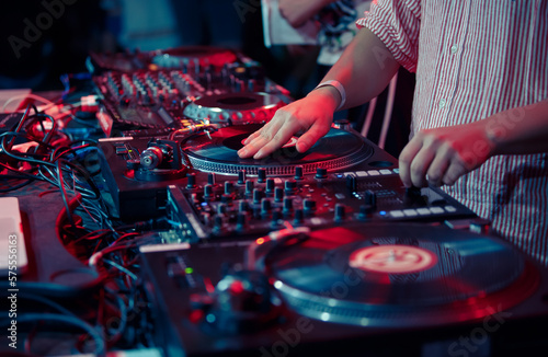 Hip hop dj scratching vinyl record on turntable. Close up photo of club disc jockey mixing records on a party