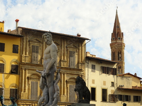 A city in Italy, yellow buildings and a statue of a man
