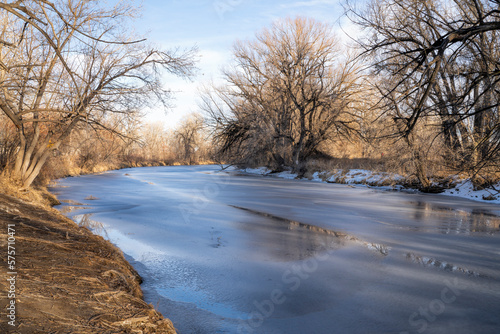 winter scenery of frozen Poudre River in Fort Collins, Colorado