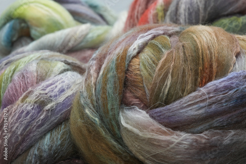 Closeup of lots of beautiful merino wheep wool fibres in a roving ready for spinning yarn on a spinning wheel as a hobby