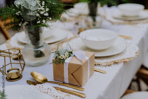 High angle view of wedding gift wrapped in eco paper papckaging and flower decoration.