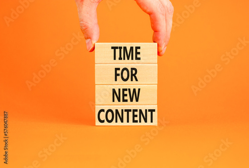 Time for new content symbol. Concept words Time for new content on wooden blocks. Beautiful orange table orange background. Businessman hand. Business time for new content concept. Copy space.