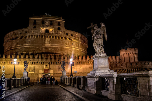 Castel Sant Angelo and angel statue on Saint Angelo bridge in Rome Italy at night