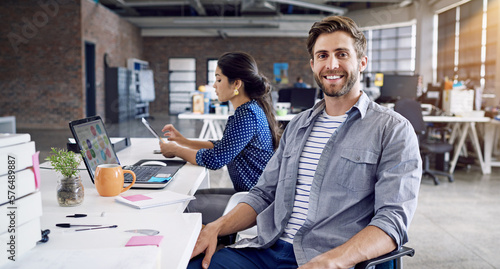 Teamwork, smile and portrait of man at desk with laptop and woman at creative agency working on project together. Leadership, collaboration and happy employees or business people at design startup.