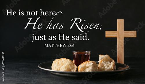 Text HE IS NOT HERE. HE IS RISEN, JUST AS HE SAID with glass of wine, bread and cross on dark background