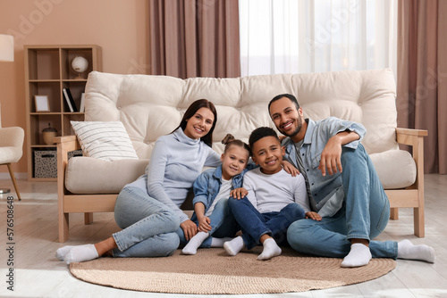 Happy international family with children near sofa at home