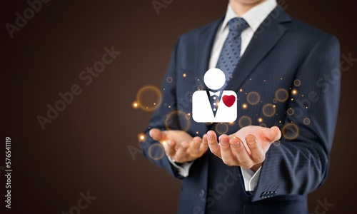 Business manager holding an icon of human with heart