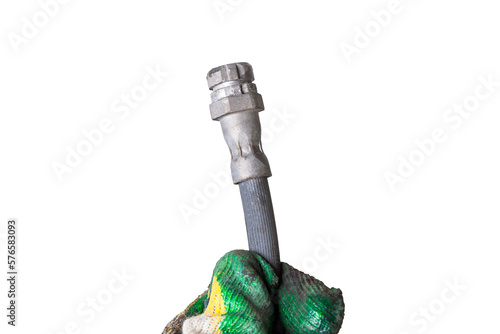 Used brake hose close-up on a white isolated background in a photo studio - high-pressure sleeve and two metal tips for connecting to the cylinders. Replacement parts in a car service.