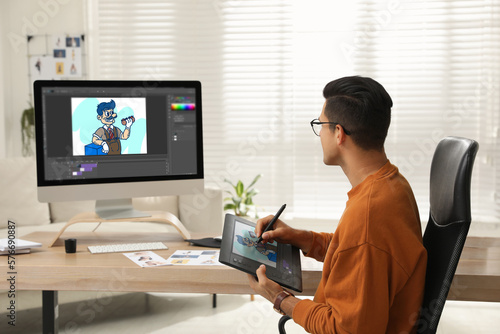 Animator using graphic tablet and computer. Illustration on screens