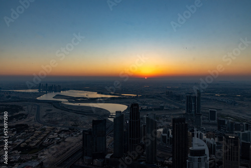 city skyline at sunrise of dubai from the burj khalifa