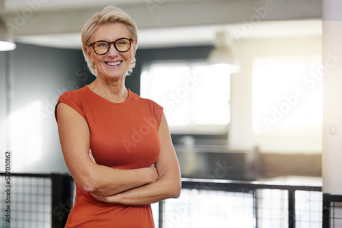 Portrait, arms crossed and smile of business woman in office with pride for career and job. Ceo glasses, boss face and happy, confident and proud elderly female entrepreneur from Canada in company.