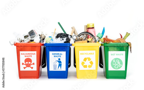The concept of waste classification for recycling. Collection of waste bins full of different types of garbage in separation according to the color of the bin isolated on white background.