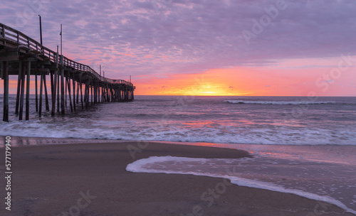 sunrise or sunset with pier at the beach